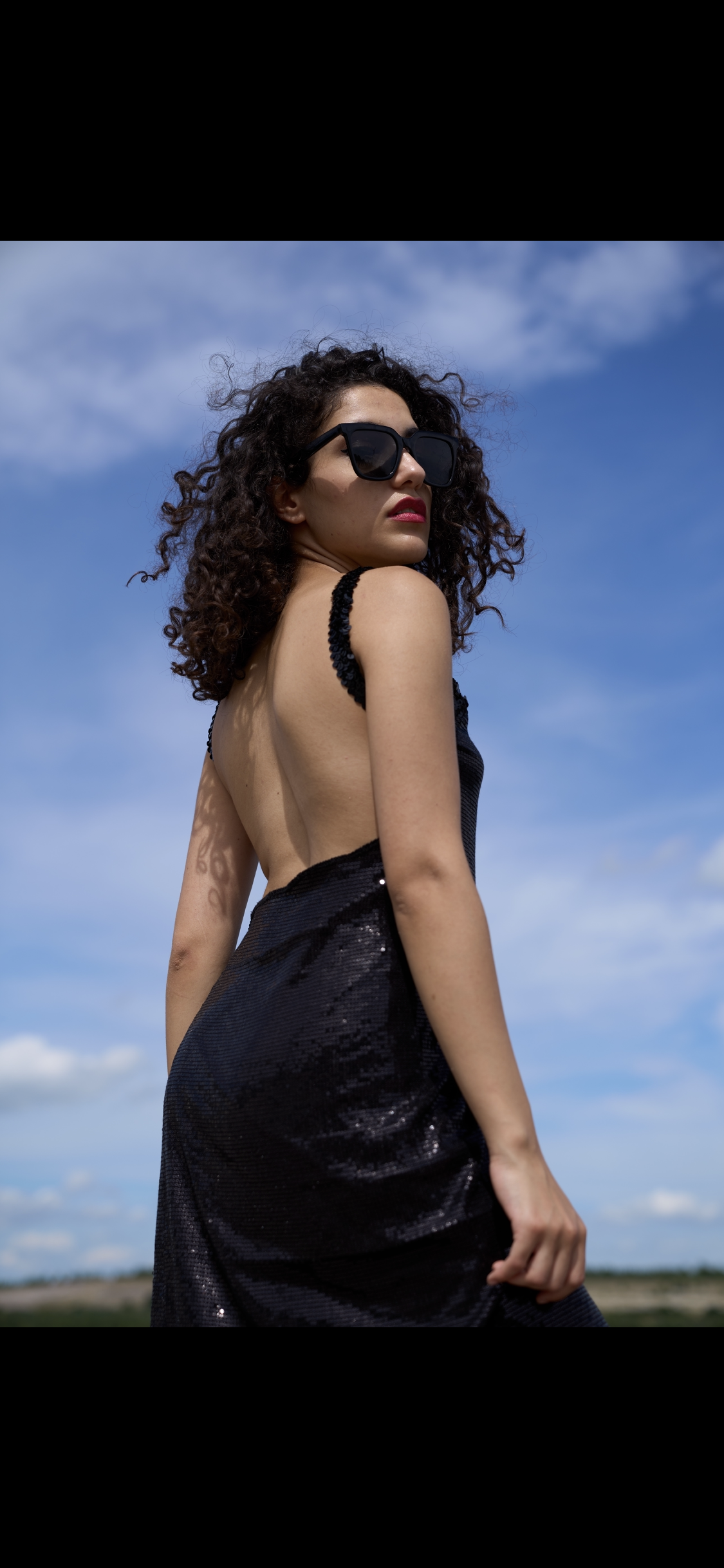 Wrap dress in black sequined fabric